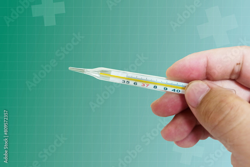 Hand holding a thermometer Measure body temperature,5 basic medical vital signs, vital signs monitoring, vital signs monitor,Health service concept and medical technology.
