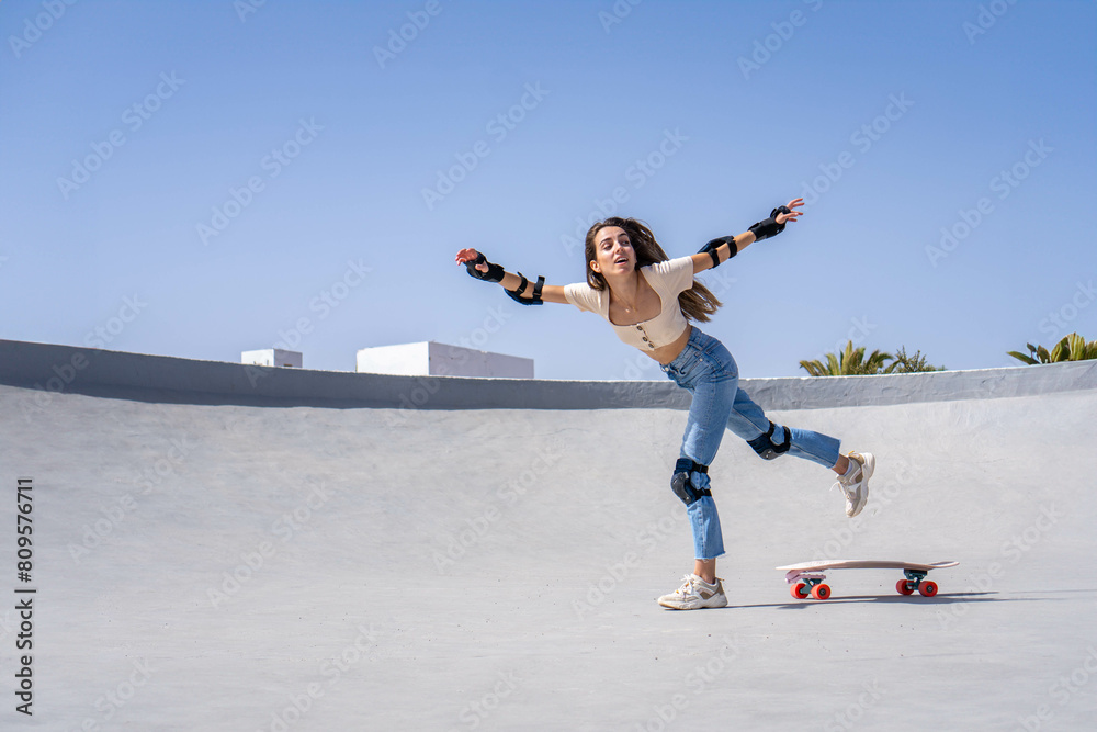 Young Woman Skateboarding on Ramp Young Woman Skateboarding on Ramp