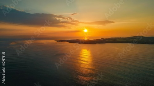sunset helicopter tour over the ocean with a stunning view of the shining sun  dark clouds  and orange sky  reflected in the calm waters