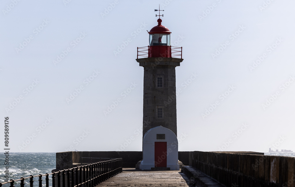 Lighthouse on a Porto city Portugal beach with dramatic waves of atlantic ocean Lighthouse on a Porto city Portugal beach with dramatic waves of atlantic ocean
