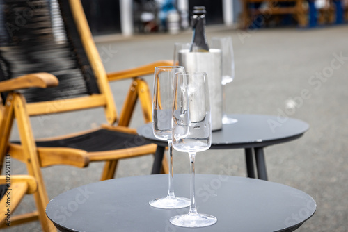 Champane glasses after a celebration, on an outside table photo