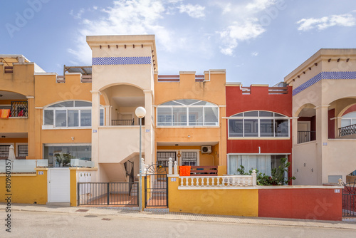 Street light in front of Colorful Spanish holiday apartments during the day