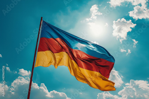 Bright Romanian flag waving under sunny blue sky