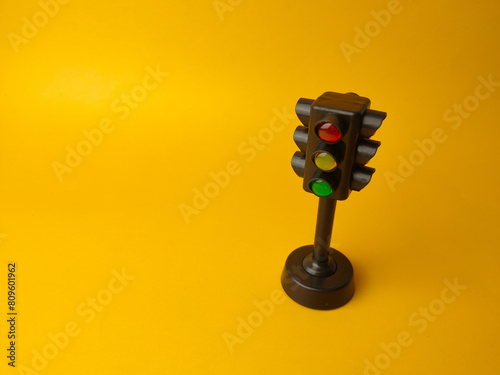 Mini traffic lights traffic lights toy on a yellow background