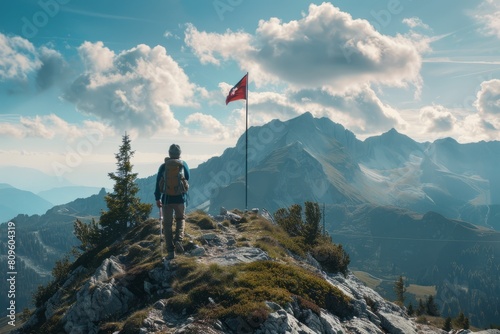 Hiker man on mountain top with a flag © viktorbond
