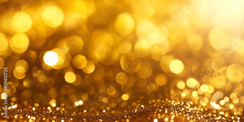 A shimmering close-up of golden bokeh lights glittering over a reflective background creating a festive mood