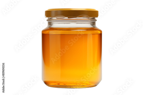 This image shows a jar of honey with a golden lid. The jar is transparent and you can see the honey inside.