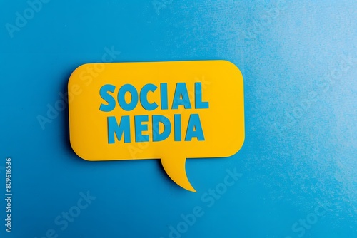 a yellow speech bubble with the word "SOCIAL MEDIA" cut out on blue background, flat lay photography, high resolution