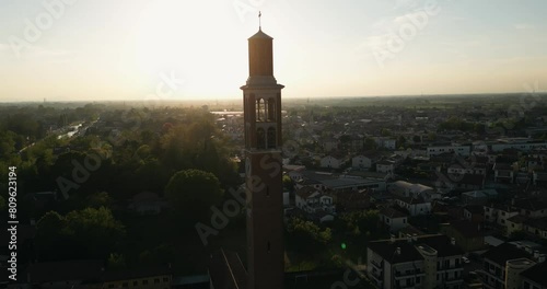 Saint Nicholas Catholic Church Tower And Mira Comune At Dusk In Veneto,  Italy. - aerial shot photo