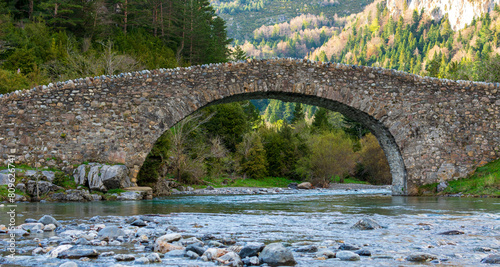 river in bujaruelo with a stone bridge, in the mountains of the pyrenees photo