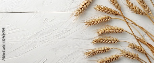 Abstract background with wheat ears on a white wooden table