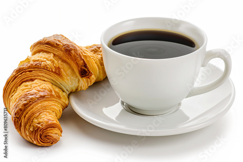 a cup of coffee and a croissant on a saucer
