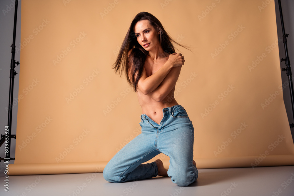 Unretouched photo of stunning girl sit posing over pastel backdrop have nude photo session isolated studio background Unretouched photo of stunning girl sit posing over pastel backdrop have nude photo session isolated studio background
