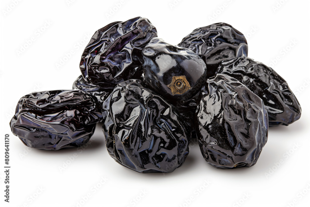 a pile of dried plums on a white surface a pile of dried plums on a white surface