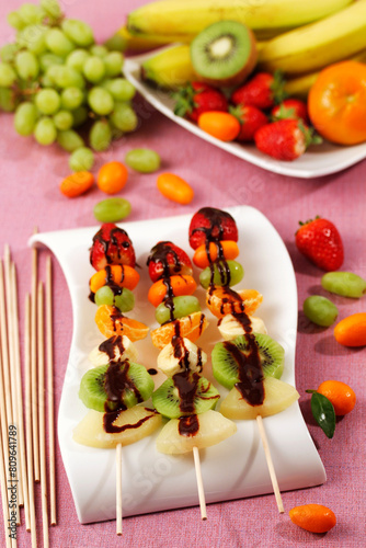 Fruit skewers with chocolate.