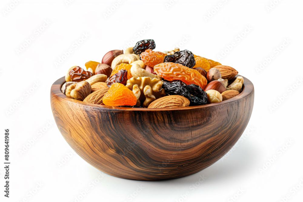 a wooden bowl filled with nuts and dried fruit