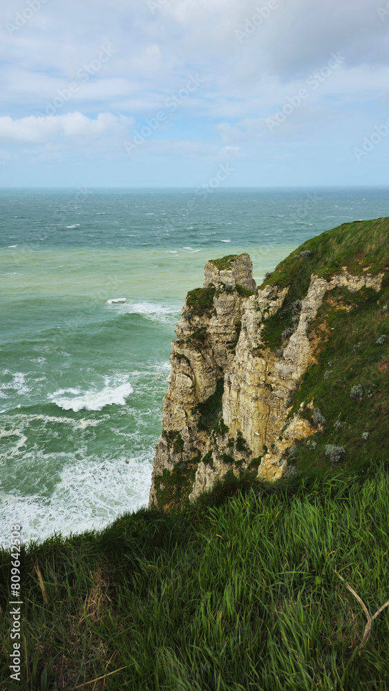 Cliffs, landscape along the Falaise d'Aval, view of the La Manche. Etretat, Normandy, France, English Channel. Natural rocks, coast. Rocks of the village of Etretat in spring in cloudy weather Cliffs, landscape along the Falaise d'Aval, view of the La Manche. Etretat, Normandy, France, English Channel. Natural rocks, coast. Rocks of the village of Etretat in spring in cloudy weather