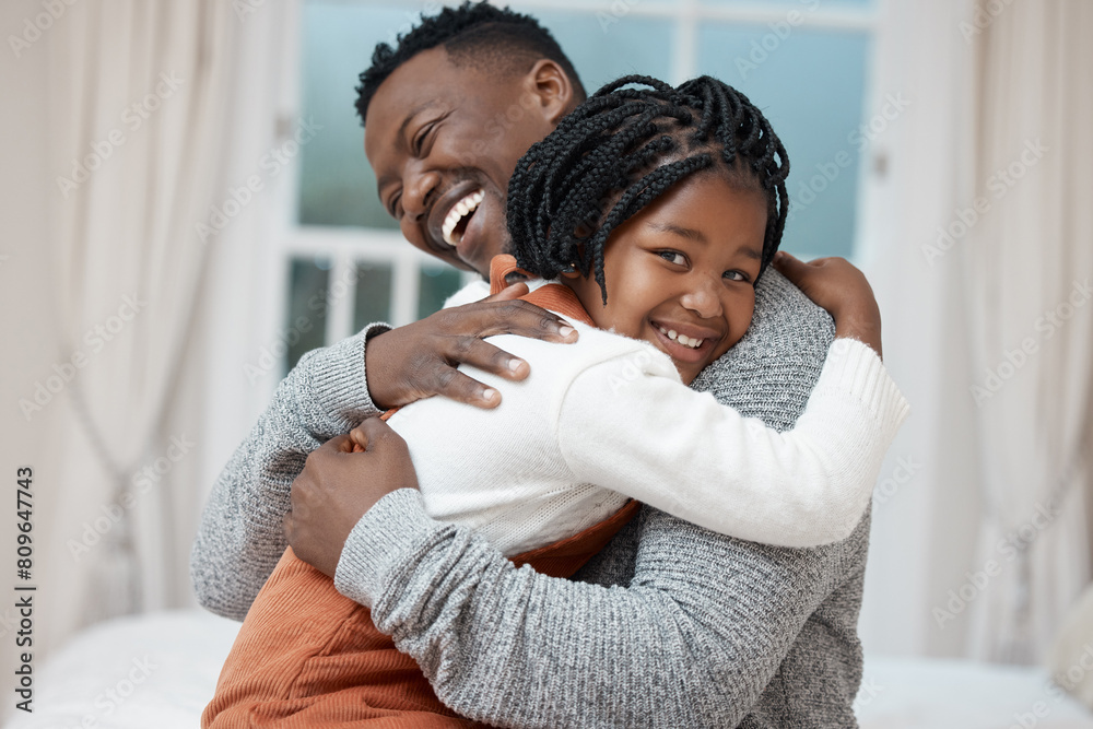 Obraz premium Dad, girl and smile with hug in bedroom for bonding, love and trust with support for child development. Black people, parent and kids in home with smile or laugh for comfort and safety for bedtime
