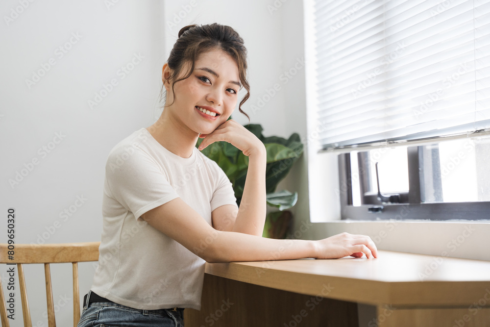 Portrait of beautiful young Asian girl at home