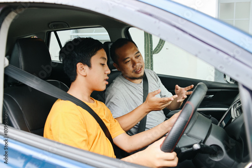 Father Teaching Teenage Son How To Drive Car. Car Lesson, Driving Course. 