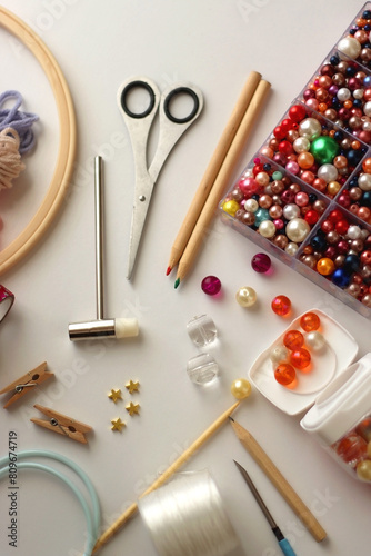 Various craft supplies on white background. Supplies for jewelry making, drawing and needlework. Selective focus. photo