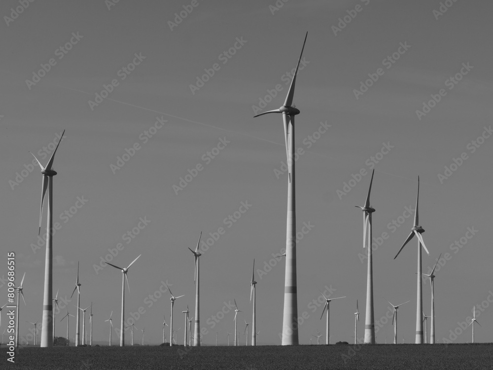 Wind turbines in a wind farm, sustainable energy, energy transition, black and white photo, copy and text space