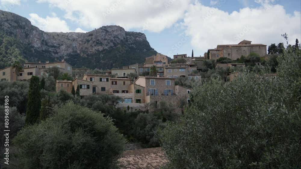 Scenic view of Deia village in Mallorca with lush greenery. Scenic view of Deia village in Mallorca with lush greenery.