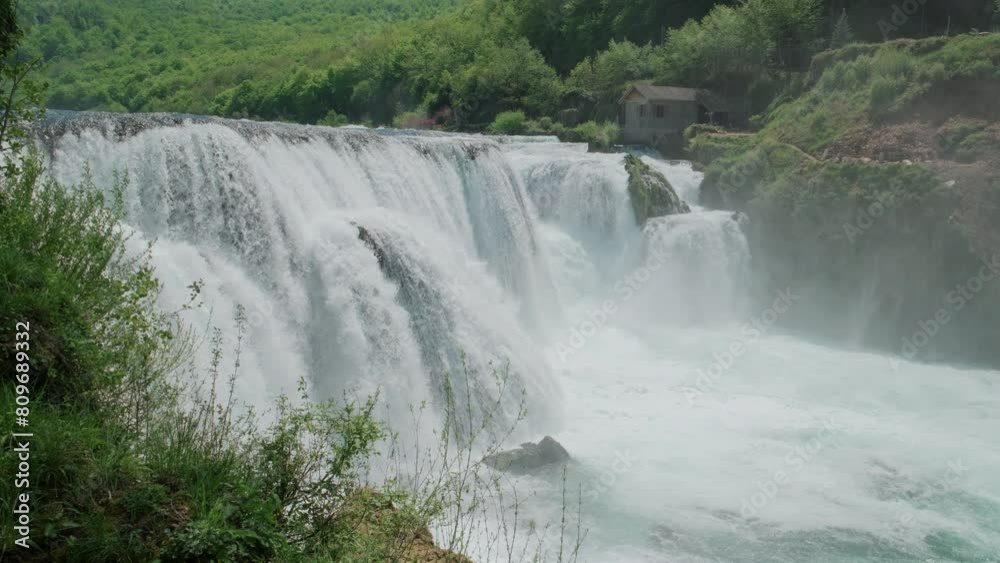 A waterfall of a pure wild river located in a green rainforest. A look at the raw power of water. The natural beauty of untouched and untamed rivers with crystal clear water A waterfall of a pure wild river located in a green rainforest. A look at the raw power of water. The natural beauty of untouched and untamed rivers with crystal clear water