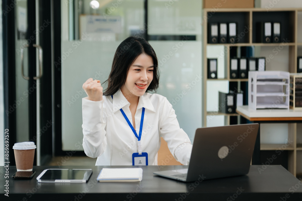 Asian business woman are delighted and happy with the work they do on their tablet, laptop and taking notes at office.. Asian business woman are delighted and happy with the work they do on their tablet, laptop and taking notes at office..