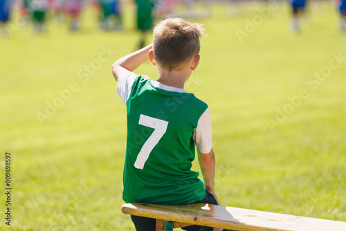 Young Boy Soccer Strike With Number Seven on Back. School Boy in Football Team. Child Sitting on Soccer Bench. Football Academy For Children