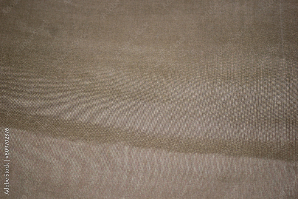 Surface of beige jersey fabric from above Surface of beige jersey fabric from above