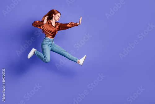Φωτογραφία Full size profile photo of pretty young woman jump fight empty space wear brown