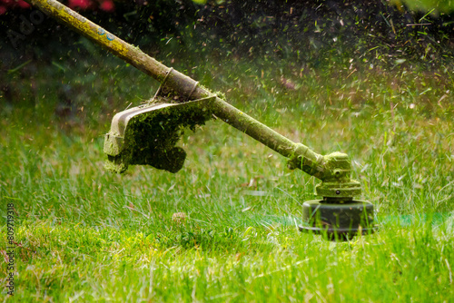 professional garden service at work. lawn care concept. cutting and mowing grass in the park. spring summer season