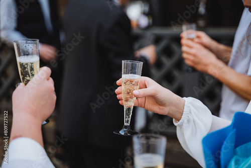 People raising champagne glasses in a toast at a special event