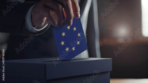 A hand casts a vote with a ballot marked by the European Union flag for democracy.