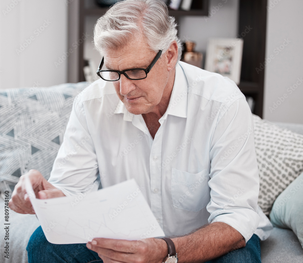 Document, reading and senior man on sofa planning mortgage, bills and debt payments at home. Receipt, saving and elderly male person with finance paperwork for pension fund in living room at house. Document, reading and senior man on sofa planning mortgage, bills and debt payments at home. Receipt, saving and elderly male person with finance paperwork for pension fund in living room at house.