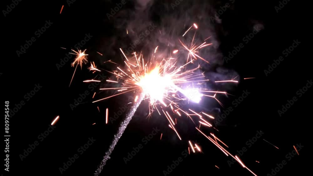Lighted fire sparkler in the dark background Lighted fire sparkler in the dark background