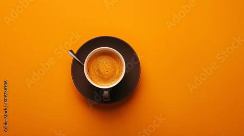 Cup of hot espresso on orange background photo