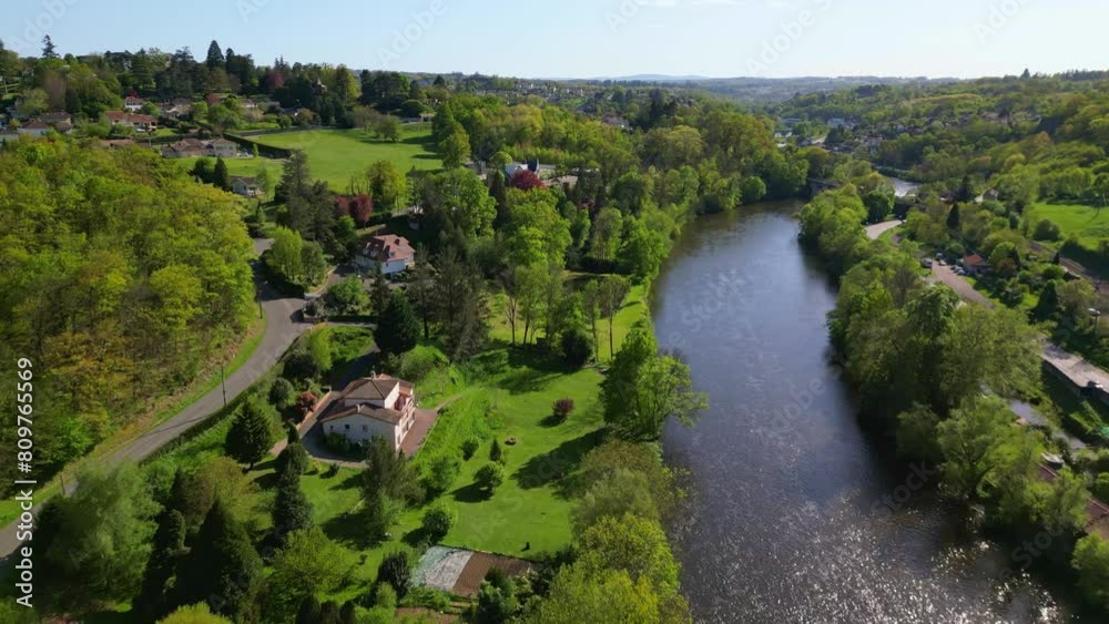 Luxury houses along green shores of Vienne river in Limoges countryside, rural and idyllic landscape of Nouvelle-Aquitaine in France. Aerial forward Luxury houses along green shores of Vienne river in Limoges countryside, rural and idyllic landscape of Nouvelle-Aquitaine in France. Aerial forward