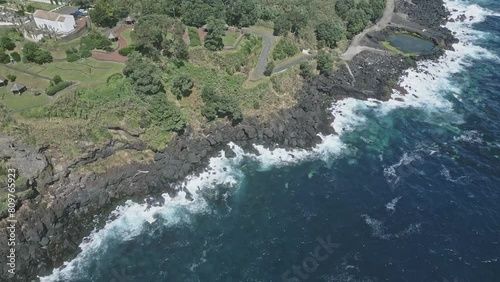 Natural pools along rocky coast of Santo Antonio, Sao Miguel island. Aerial top-down forward photo