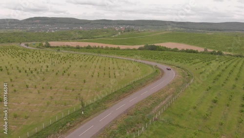 sports car driving down the road, drone footage photo