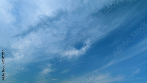 Cirrus or feather clouds against a blue sky. Natural beautiful scene. Purity and serenity concepts. Timelapse. photo