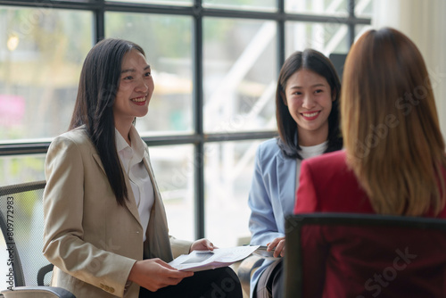 Asian business woman talk, consult, discuss working with new startup project idea presentation analyze plan marketing and investment in the office.