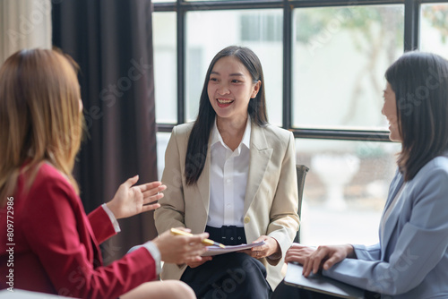 Asian business woman talk, consult, discuss working with new startup project idea presentation analyze plan marketing and investment in the office.