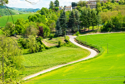 Winding road along the hills of oltrepo pavese, vinery area in italy (lombardy region) at the borders with piedmont and emilia romagna. it's famous for valuables wines, mainly sparkling wines. photo