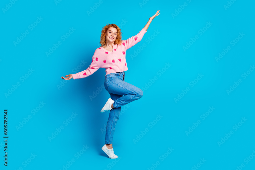 Full length photo of attractive young woman playful have fun dressed stylish pink clothes isolated on blue color background