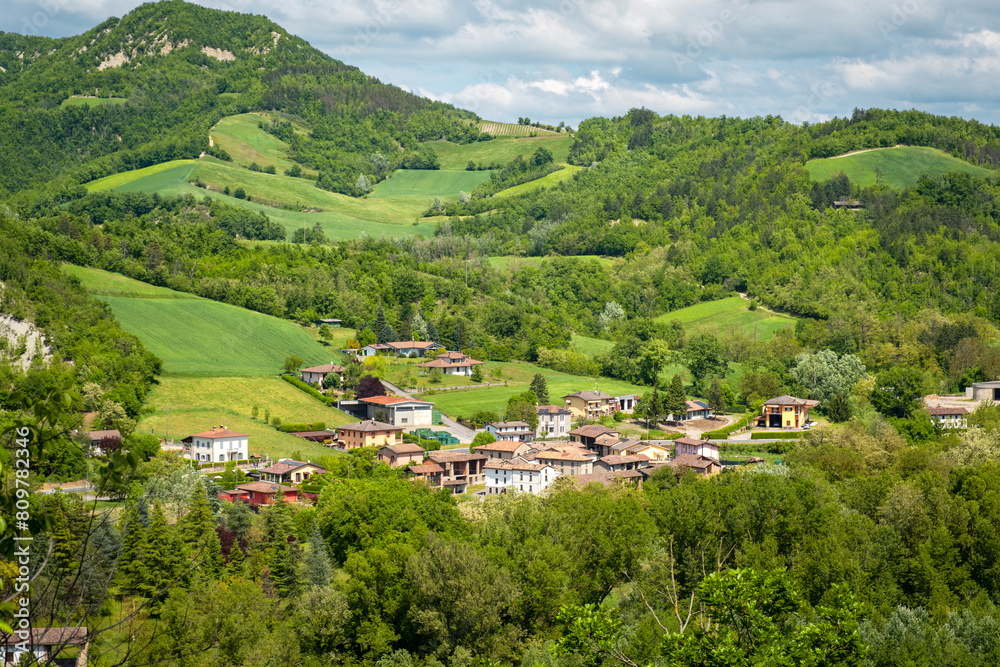 springtime panorama of the hills of oltrepo pavese, vinery area in italy (lombardy region) at the borders with piedmont and emilia romagna. it's famous for valuables wines, mainly sparkling wines.