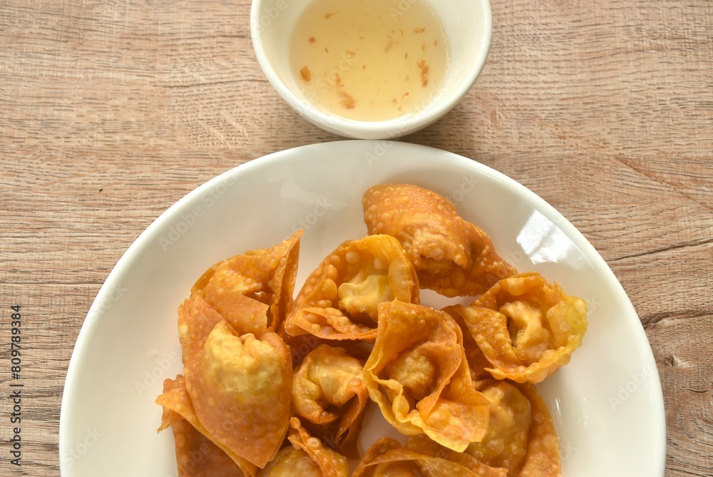 crispy fried dumpling paste stuffed chop pork and shrimp dipping sweet chili sauce on plate crispy fried dumpling paste stuffed chop pork and shrimp dipping sweet chili sauce on plate