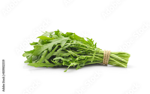 Fresh arugula bunch isolated on white background. Dietetic salad ingredient, healthy eating.  