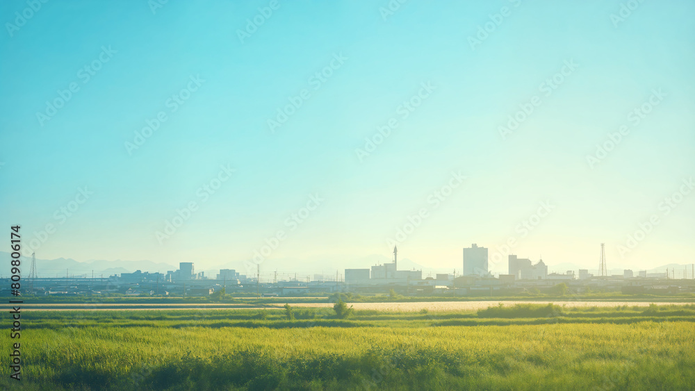 Distant city skyline at sunrise, Contrast of modern urban development and rural countryside in morning light landscape and fields